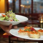 Restaurants - Person Holding Pastry Dishes on White Ceramic Plates