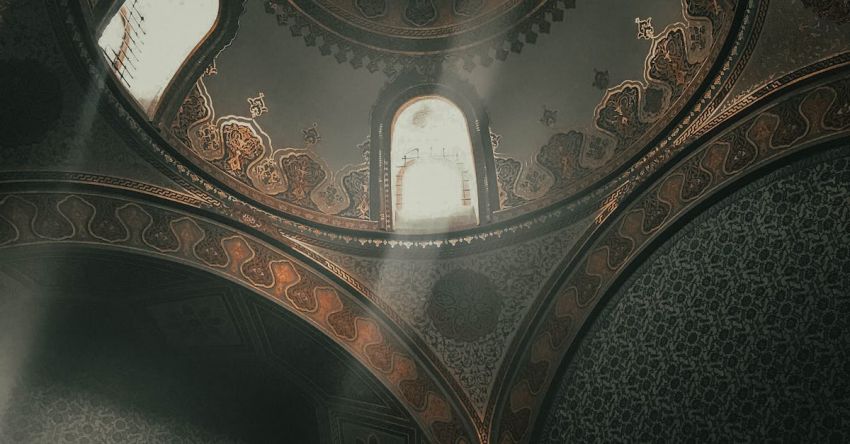 Visits - From below dome inside of ancient Topkapi Palace located in Istanbul decorated with arches and golden ornaments